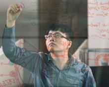 Student works on a problem at a white board